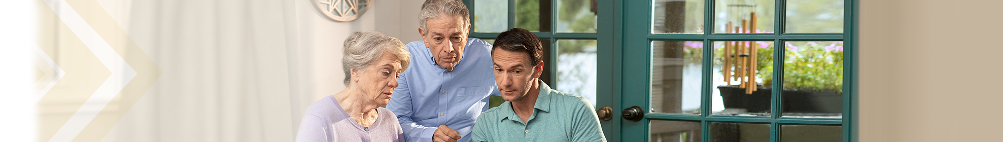 Three people looking at caregiver tips on a computer. Not actual patients.