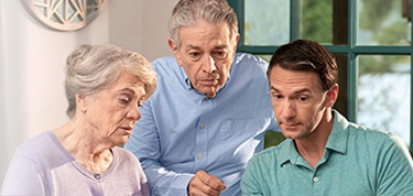 Three people looking at caregiver tips on a computer.